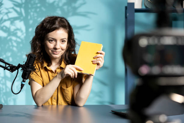 istock Jolly content creator in studio doing novel summaries for interested readers 2198691845