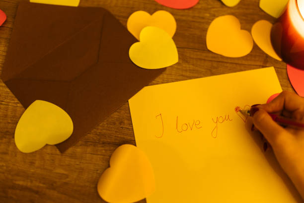 istock Handwriting 'I Love You' With Hearts on Wooden Table for Romantic Message 2198692016