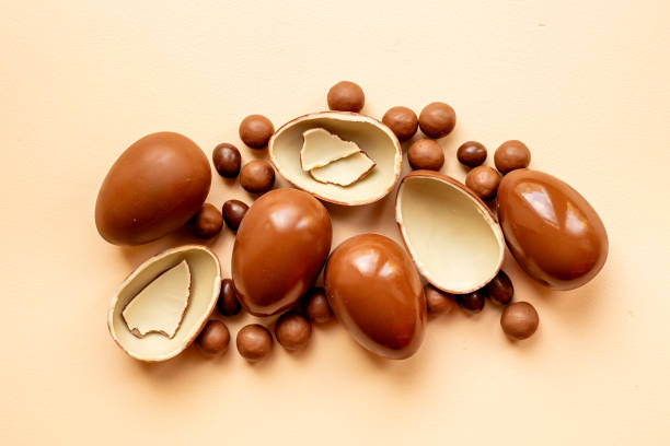 istock Chocolate background. Broken and whole chocolate eggs, top view 2198692117