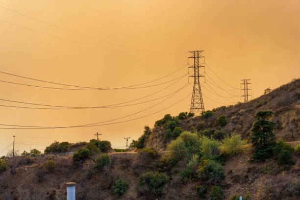 Los Angeles, California - January 8, 2025: View of power lines on hillside during wildfire smoke in Los Angeles.