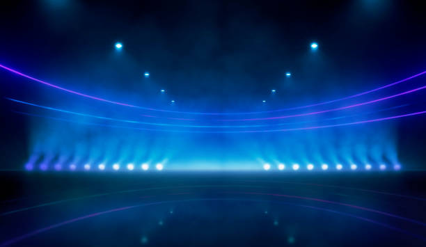istock Blue neon stadium background illuminated with lamps mirroring on ground. Science, product and sports technology background 2198697657