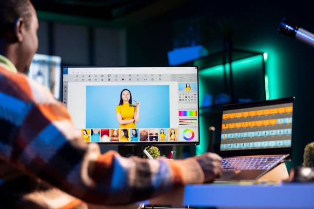 istock Professional graphic designer retouching images on dual monitors 2198698311