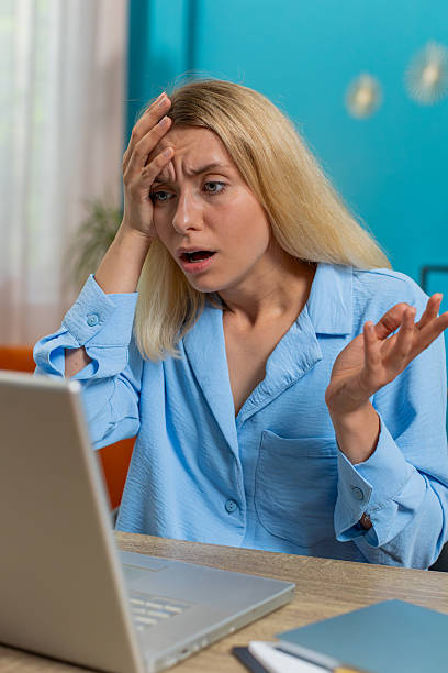 istock Frustrated woman having software problems with laptop angry girl nervous seeing error mistake virus 2198701968