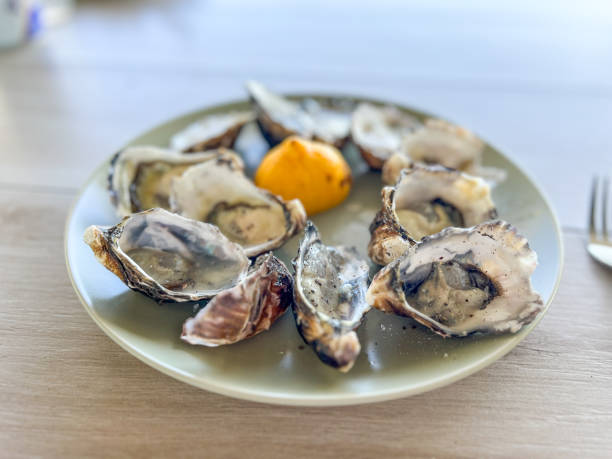 istock A plate of fresh oysters sits on a table with a softly blurred table in the background, evoking a relaxed dining experience 2198702729