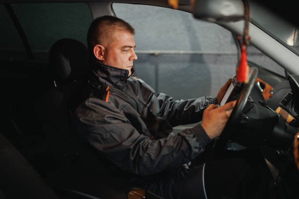 istock Auto Mechanic Running Diagnostics on Car Tablet 2198704648