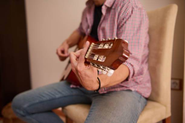 istock Person playing an acoustic guitar indoors in a relaxed setting 2198707672