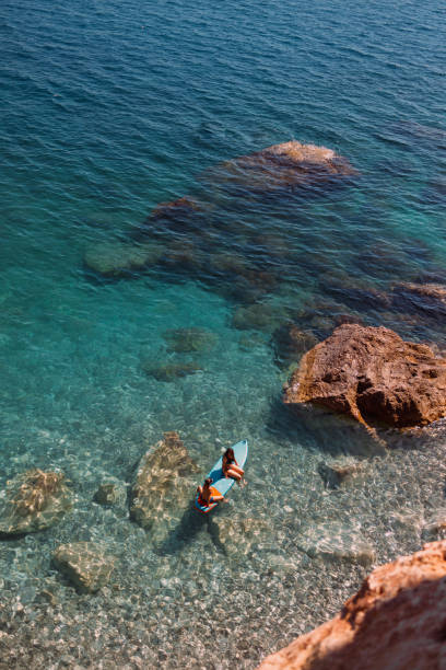 istock Enjoying the paddle board at sea 2198708441