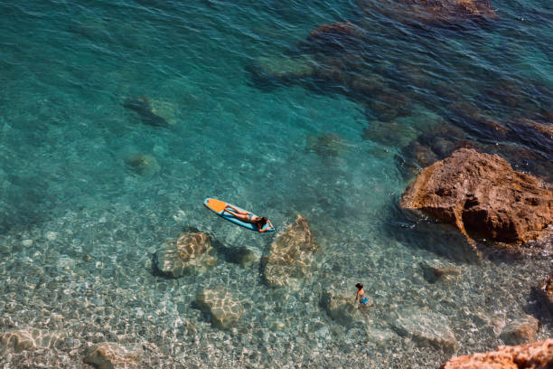 istock Enjoying the paddle board at sea 2198708444