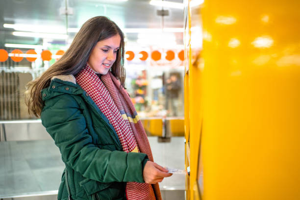 istock A woman buys a ticket for transport 2198710378