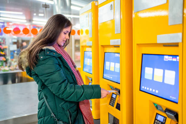 istock A woman buys a ticket for transport 2198710955