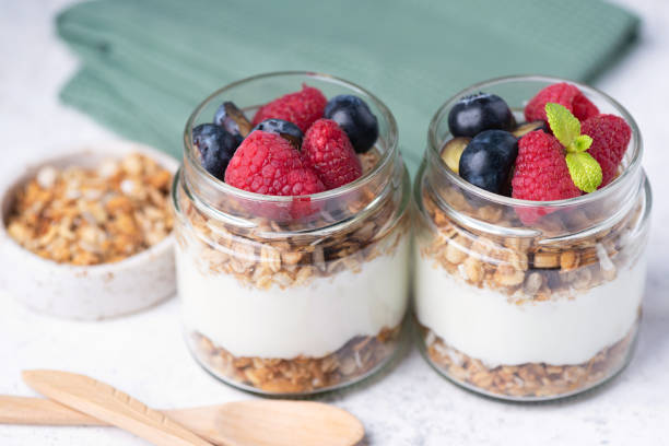 istock Greek yogurt parfait with granola and fresh berries 2198711574