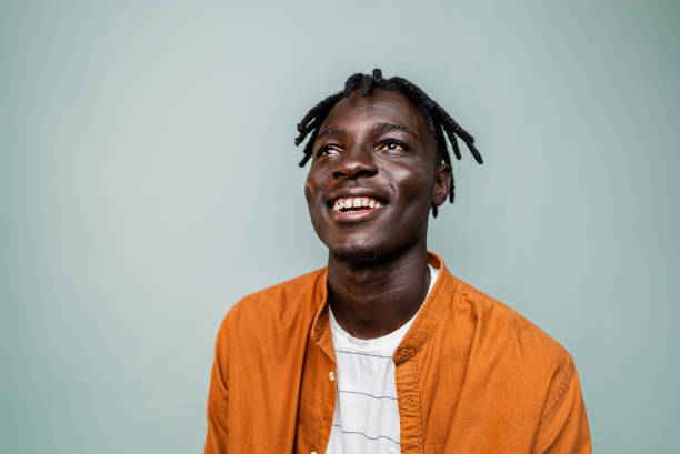 istock Young man contemplating at gray background 2198711819