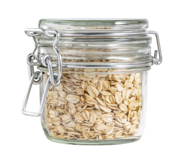 istock Sealed glass jar filled with rolled oats isolated on white background 2198712533