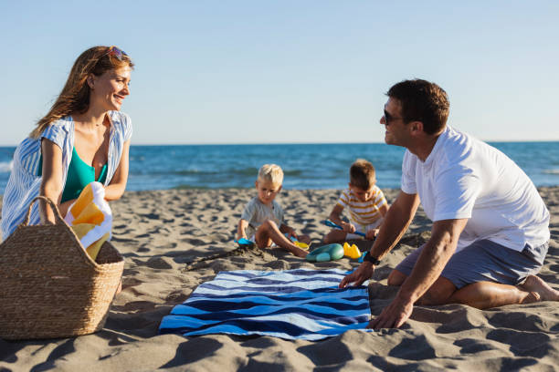 istock Happy family enjoying beach vacation together 2198712723