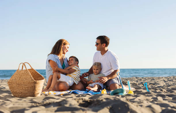 istock Happy family enjoying beach vacation together 2198712751