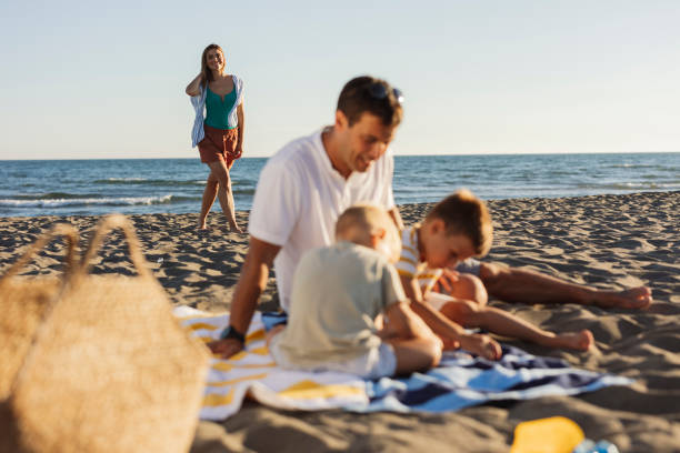 istock Family enjoying summer vacation on the beach 2198712851