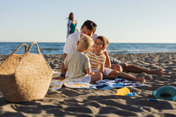 istock Father and children enjoying a day at the beach 2198712891