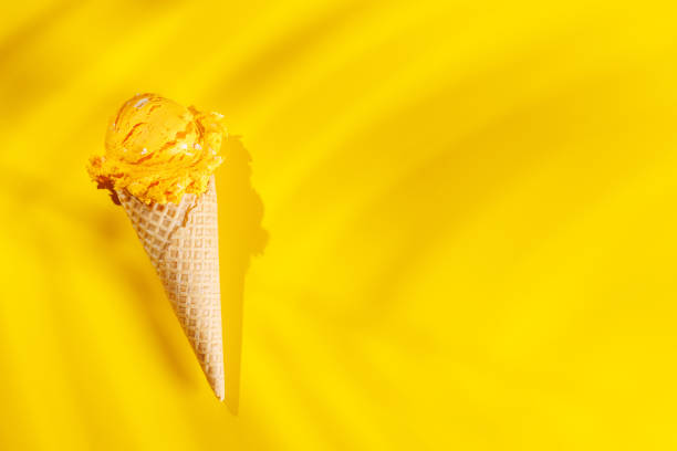 istock A refreshing ice cream cones set against a vibrant yellow background 2198713338