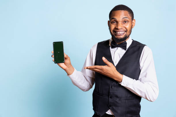 istock Hotel concierge staff holding a smartphone with chroma key display 2198716921