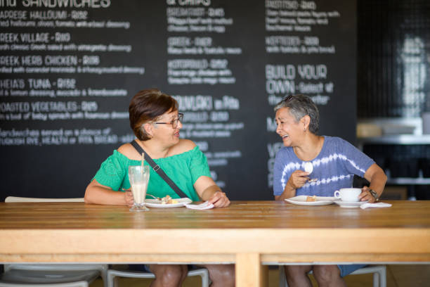 istock Two Senior Women laughing having something to eat in drink inside a restaurant 2198717129