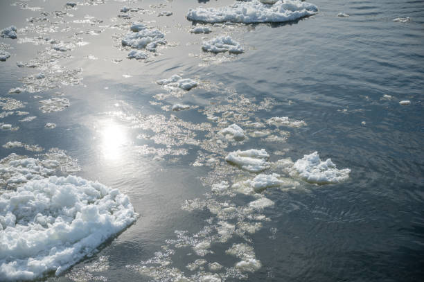 Reflection of the sun on frozen St. Lawrence river during winter day in Quebec city