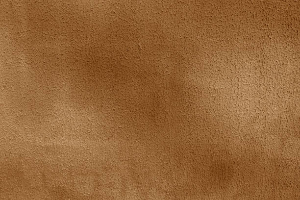 istock brown background of old vintage wall with obvious relief. 2198725428