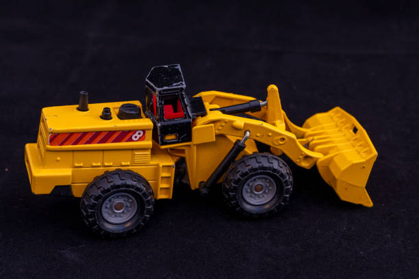 istock Yellow Toy Front Loader with Black Cabin on Black Background 2198726407