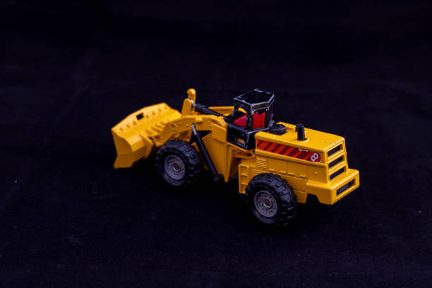 istock Toy Heavy Equipment Machine on Black Background 2198726604