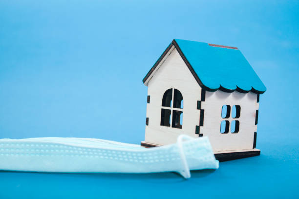 istock medical mask and house on blue background 2198727048