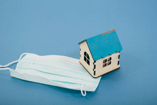 istock medical mask and house on blue background 2198727049