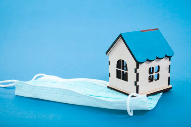 istock medical mask and house on blue background 2198727072
