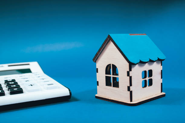 istock calculator and house on blue background 2198727099