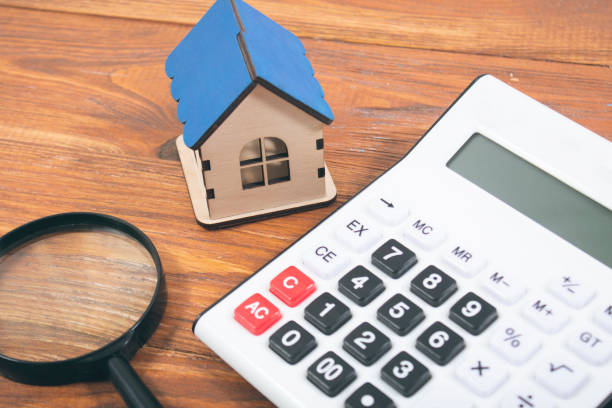 istock magnifying glass, house and calculator on the table 2198727131