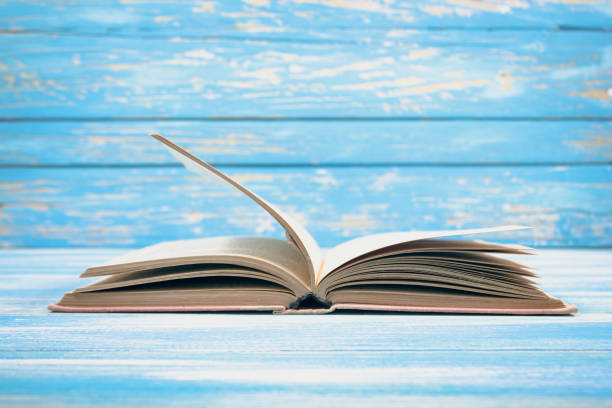 istock open book on blue wooden background 2198727144