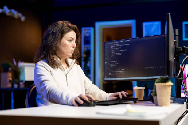 istock Woman in living room working from home coding 2198727318
