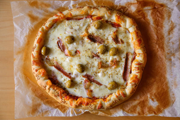 Tasty homemade delicious pizza served on a dinner table, top view