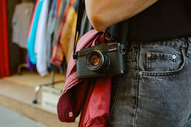 Tourist or a local woman using analog film camera to document her life. Vintage, retro concepts, slower pace of life.