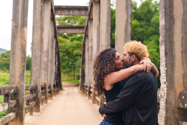 Interracial couple are having fun by the river.