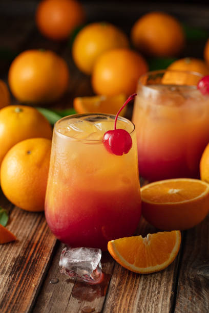 istock Classic tequila sunrise cocktail on an old wooden table. 2198730764