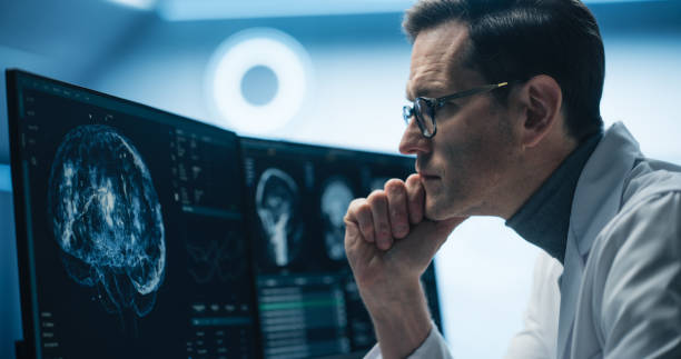 istock Portrait of Scientist Analyzing Brain Scans on Multiple Monitors in High-tech Laboratory. Advanced Medical Imaging Technology Displays Detailed Neurological Data for Advanced Research and Diagnosis 2198730801
