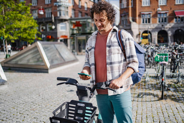 istock Tourist using smartphone and renting electric bicycle in Copenhagen 2198730932