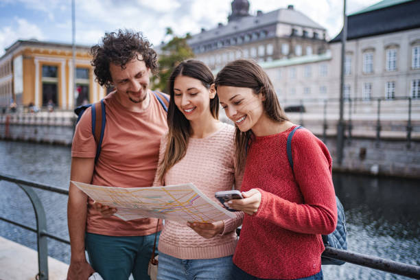 istock Tourists using map and smartphone in Copenhagen, Denmark 2198731518