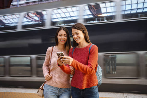 istock Tourists using smartphone app at Copenhagen Central Station with high speed train passing by 2198731610