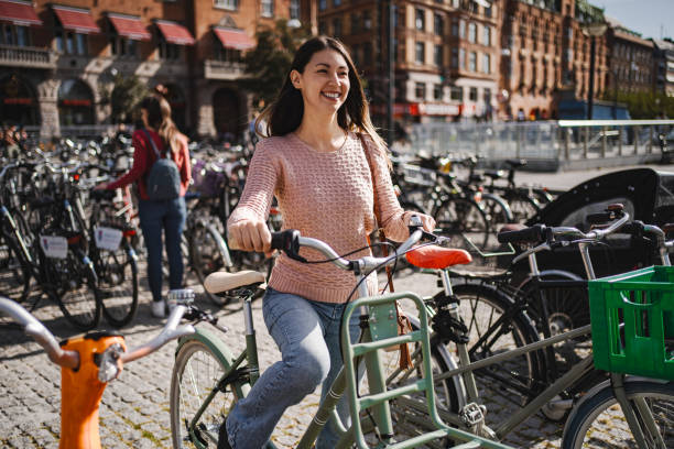 istock Young woman getting her bicycle in Copenhagen, Denmark 2198731919