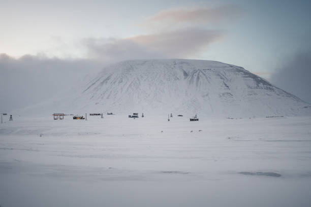 istock Cabins underneath snowy mountain at sunset outside Longyearbyen, Svalbard 2198733681