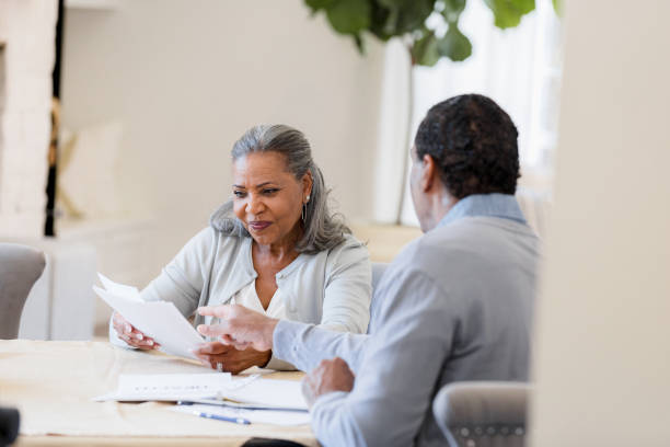 istock Mature Couple Reviewing Documents Together at Home 2198733743