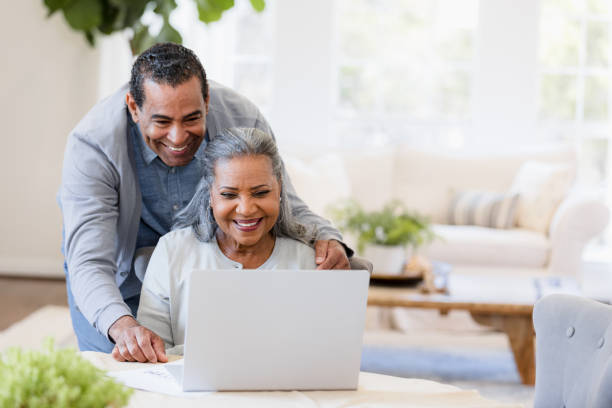 istock Happy senior couple using laptop together at home 2198733750