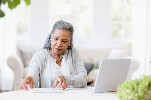 istock Senior African-American Woman Working at Home, Using Laptop 2198733759