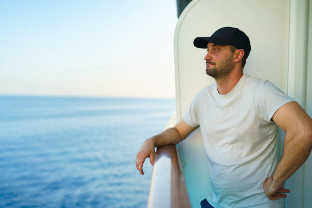 istock Man looking at the view from a cruise ship 2198734265