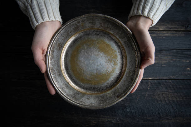 istock Woman hands holding blank plate on wooden table 2198735028